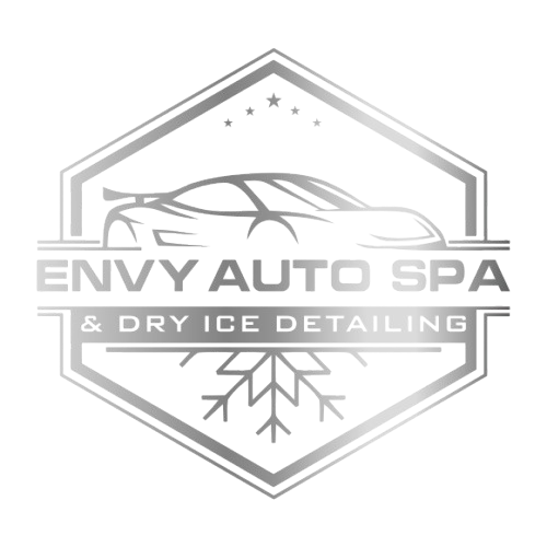 A silver emblem with the words " snow auto dx ".
