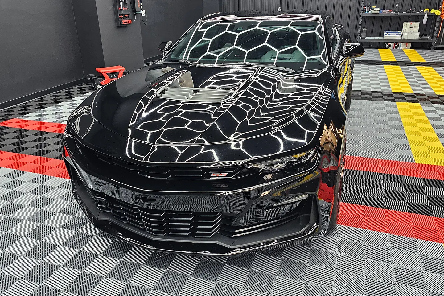 A black car with white and silver designs on it.