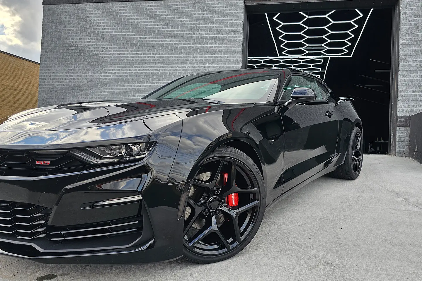A black car parked in front of a building.