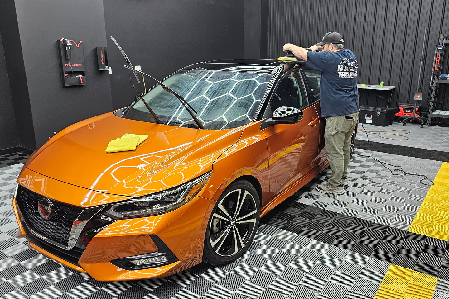 A man is working on a car in the garage.