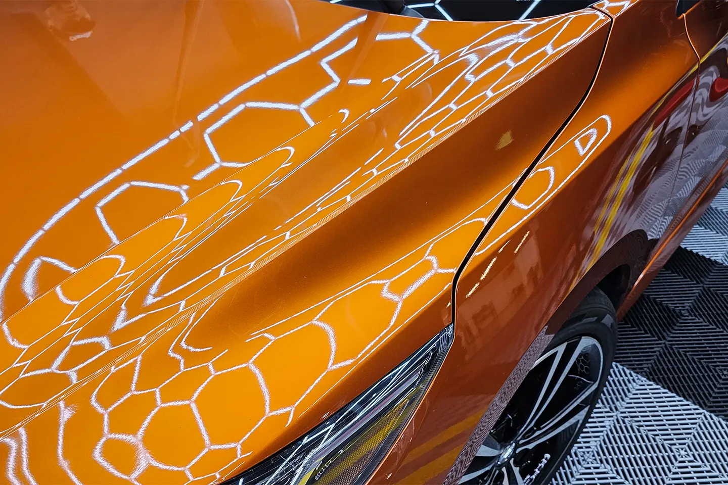 A close up of the side of an orange car